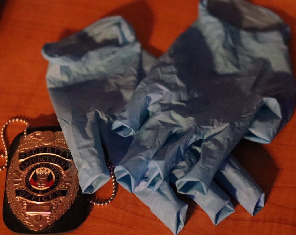 stock image gloves and police badge